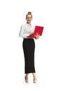 Full length portrait of a smiling female teacher holding a laptop isolated against white background Royalty Free Stock Photo