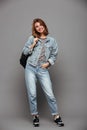 Full length portrait of a smiling girl in denim jacket Royalty Free Stock Photo