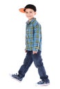 Full length portrait of smiling little boy in jeans and cup Royalty Free Stock Photo