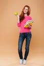 Full length portrait of a smiling pretty redhead girl Royalty Free Stock Photo