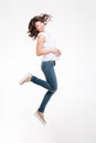 Full length portrait of a smiling pretty woman jumping Royalty Free Stock Photo