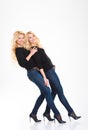 Full length portrait of a smiling sisters twins
