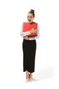 Full length portrait of a smiling female teacher holding a laptop isolated against white background Royalty Free Stock Photo