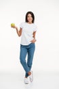 Full length portrait of a smiling woman holding green apple Royalty Free Stock Photo