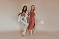 Full-length portrait of smiling woman in canotier and white pants. Studio shot of well-dressed girls..