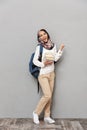 Full length portrait of a smiling young arabian woman Royalty Free Stock Photo