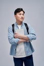 Full length portrait of a smiling young man dressed carrying backpack isolated, holding books, jumping Royalty Free Stock Photo