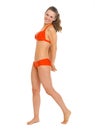 Full length portrait of smiling young woman in swimsuit Royalty Free Stock Photo