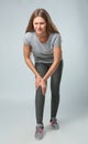 Full length portrait of sportswoman having knee problems