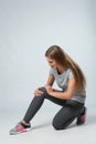 Full length portrait of sportswoman having knee problems