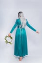 Full length portrait of a standing back princess in a medieval, fantasy, turquoise dress with ash hair and a silver crown