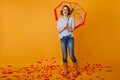 Full-length portrait of stunning curly girl wears trendy rubber boots. Indoor photo of laughing adorable woman posing