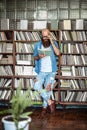 Full length portrait of stylish bearded man reading book