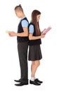 Full length portrait of teenagers in school uniform with books on white Royalty Free Stock Photo