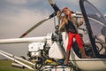 Full length portrait of tween girl looking at sky from open cockpit of helicopter