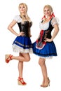 A full length portrait of two beautiful women in a traditional costume isolated on white. Oktoberfest