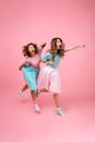 Full length portrait of a two excited pretty girls Royalty Free Stock Photo