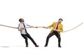 Full-length portrait of two motivated and concentrated employees doing tug of war isolated over white background Royalty Free Stock Photo