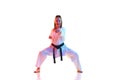 Full length portrait of woman, Kung Fu teacher in uniform with black melt isolated over white studio background.