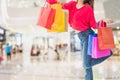 Full length portrait woman standing carry shopping bag in hand, fun and happy,background in mall,with concept of shopping and Royalty Free Stock Photo