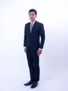 Full length portrait of a young asian businessman standing Royalty Free Stock Photo