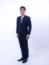 Full length portrait of a young asian businessman standing - Happy smiling businessman Royalty Free Stock Photo