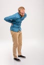 Full length portrait of young bearded man having back pain Royalty Free Stock Photo