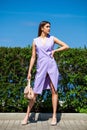 Full length portrait of a young beautiful woman in a lilac dress