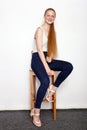 Full length portrait of young beautiful redhead beginner model woman in white t-shirt blue jeans practicing posing showing emotion Royalty Free Stock Photo