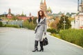 Portrait of young beautiful woman in gray coat posing in autumn park in Moscow Royalty Free Stock Photo