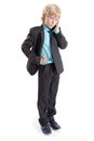 Full length portrait of young boy a businessman standing white background with mobile phone in hand Royalty Free Stock Photo