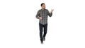Young confident man in shirt and jeans walking towards camera and pointing to the sides on white background. Royalty Free Stock Photo