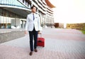 Full length portrait of young executive with a suitcase. Royalty Free Stock Photo