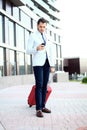 Full length portrait of young executive with a suitcase. Royalty Free Stock Photo