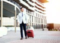 Full length portrait of young executive with a suitcase. Royalty Free Stock Photo