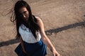 Portrait of young fashionable brunette woman practicing model posing outdoors against urban style background of grey concrete wall Royalty Free Stock Photo