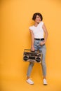 Full length portrait of a young girl holding record player Royalty Free Stock Photo