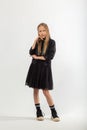 A full-length portrait of a young girl with long brown hair dressed in a hooligan style Royalty Free Stock Photo