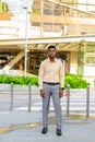 Full length portrait of young handsome African businessman in city Royalty Free Stock Photo