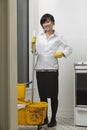Full length portrait of young maidservant with mop and bucket Royalty Free Stock Photo