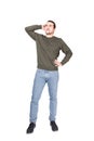Full length portrait of young man, hand to nape, thoughtful and confused grimace, isolated on white background. Guy planning his Royalty Free Stock Photo