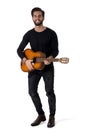 Full Length Portrait of Young Man Playing Guitar in Studio Royalty Free Stock Photo