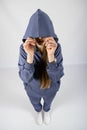 Full length portrait of young sporty fitness women in blue cotton hooded sweatsuit casual outfit. studio shot of blonde