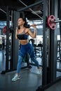 Woman doing reverse lunges on Smith machine at gym Royalty Free Stock Photo