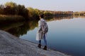 Full length portrait of young teenage girl walking near the lake. Royalty Free Stock Photo