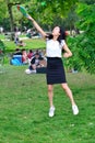 Full length portrait of a young Woman playing badminton in the Vondelpark, Amsterdam