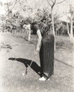 Full length portrait of young woman playing golf on field Royalty Free Stock Photo