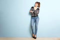 Full length young woman smiling against blue wall Royalty Free Stock Photo