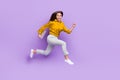 Full length profile photo of active carefree person hold netbook rush jump on violet color background