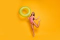 Full length profile photo of beautiful lady slim bronze body sunbathing rejoicing beach pool hold green float circle Royalty Free Stock Photo